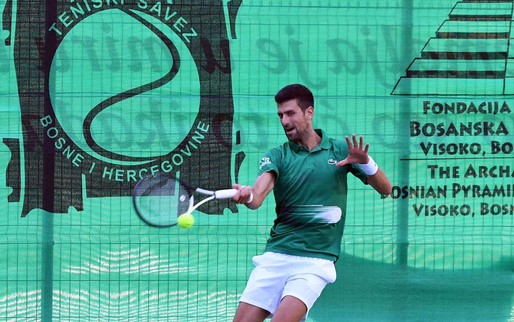 Novak Djokovic returns the ball during an exhibition match, organised to mark the opening of a tennis court at the "Archaeological park of the Bosnian pyramid" near Visoko, north of Sarajevo. -- AFP