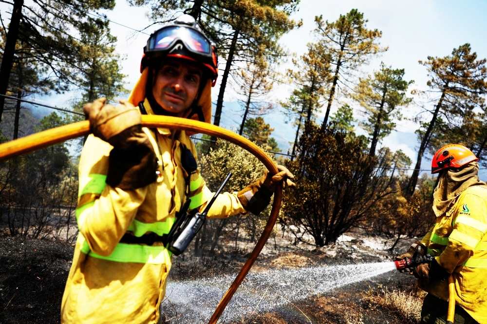 Firefighters from Extremadura contain a wildfire during the second heatwave of the year in the vicinity of Riomalo de Arriba, Spain, on Thursday. -- Reuters