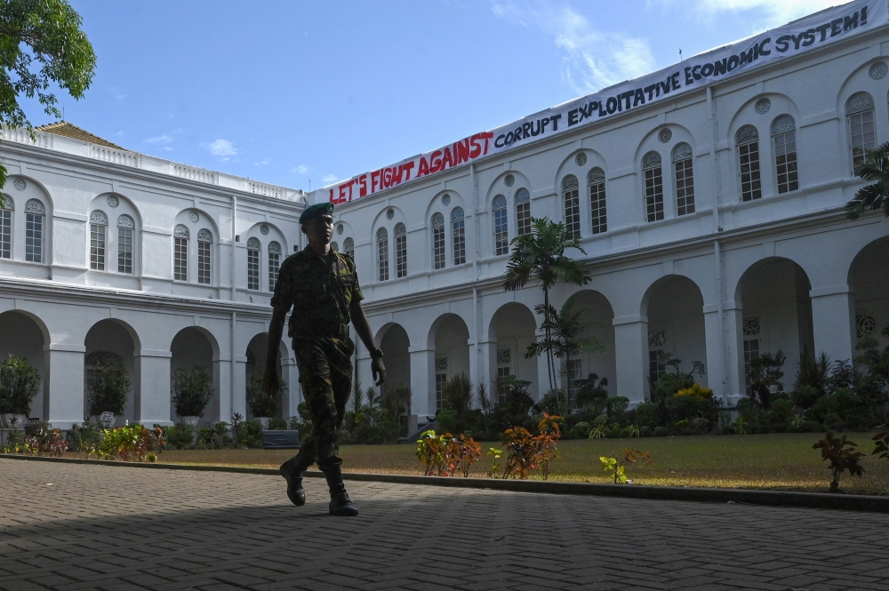 A special task force cadet walks at the lawn of the Sri Lankan President's official residence in Colombo on July 15, 2022, after it was overrun by anti-government protestors on July 9. 