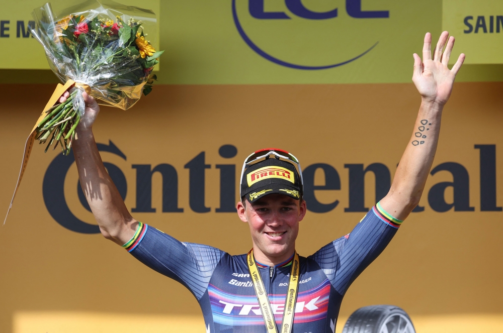Trek-Segafredo team's Danish rider Mads Pedersen celebrates on the podium after winning the 13th stage of the 109th edition of the Tour de France cycling race, 192,6 km between Le Bourg d'Oisans in The French Alps, and Saint-Etienne in central France, on July 15, 2022. (Photo by Thomas SAMSON / AFP)

