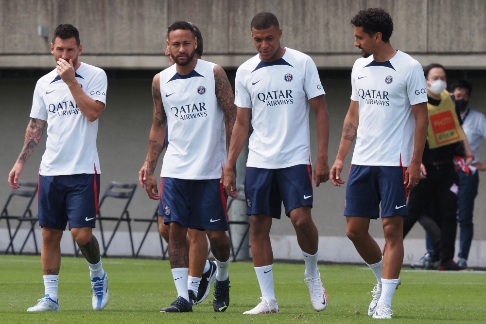 PSG players (L-R) Lionel Messi, Neymar Jr, Kylian Mbappe and Marquinhos enter the pitch to attend a soccer clinic at a stadium in Tokyo. -- AFP