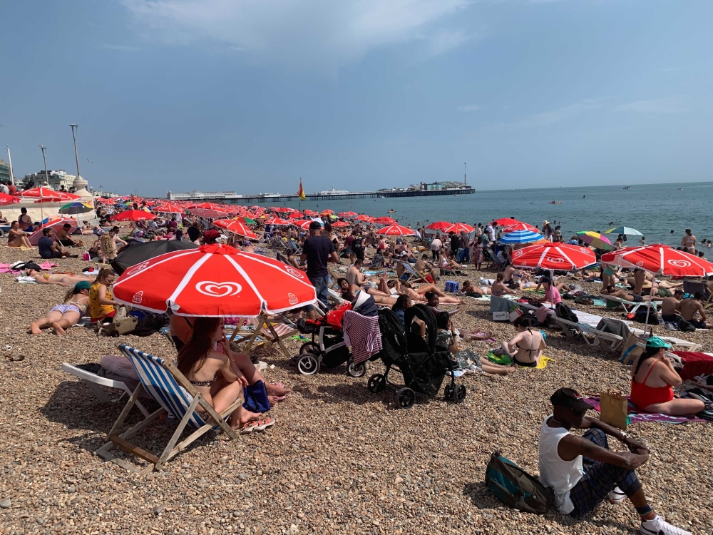 Beachgoers in Brighton, a seaside town just an hours train ride from London, on Monday, July 18, 2022. (Saskia Solomon/The New York Times)