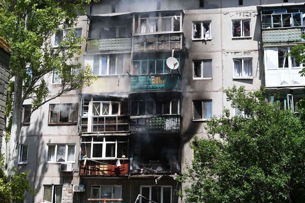 A picture shows a damaged building by fire after an air strike hit the courtyard of civilian residences in the centre of Kramatorsk, eastern Ukraine, on Tuesday. — AFP