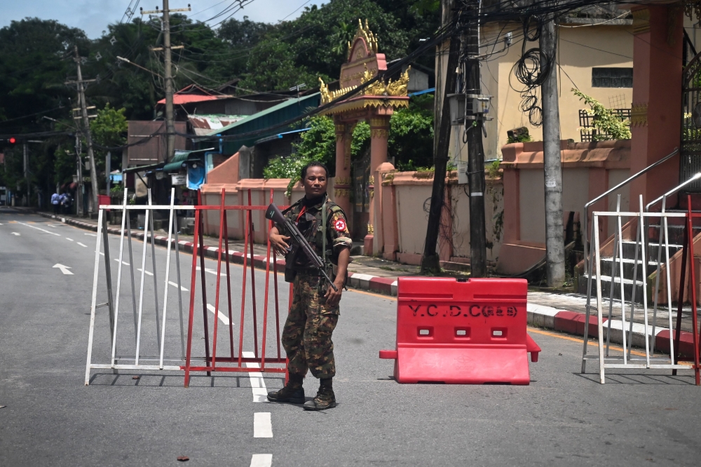 A member of the Myanmar security forces stands by a checkpoint in Yangon on Tuesday, on the 75th Martyrs' Day.  — AFP