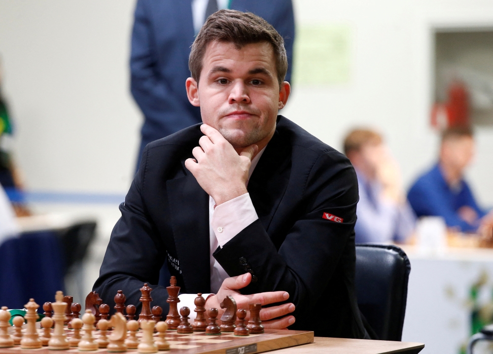 FILE PHOTO: Chess - 2018 World Rapid and Blitz Chess Championships - Rapid Open - Saint Petersburg, Russia - December 26, 2018. Magnus Carlsen of Norway plays against Adam Tukhaev of Ukraine. REUTERS/Anton Vaganov/File Photo
