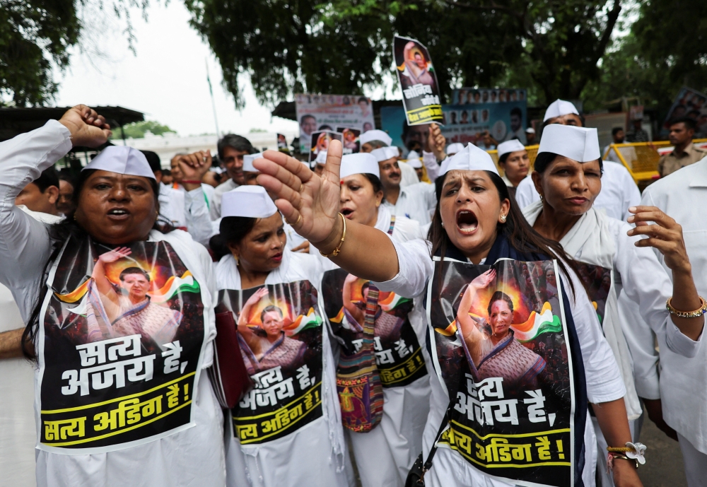 Supporters of the Congress party shout slogans as they protest outside the party headquarters after their leader Sonia Gandhi was summoned by the Enforcement Directorate in a money laundering case, in New Delhi, on Thursday. — Reuters