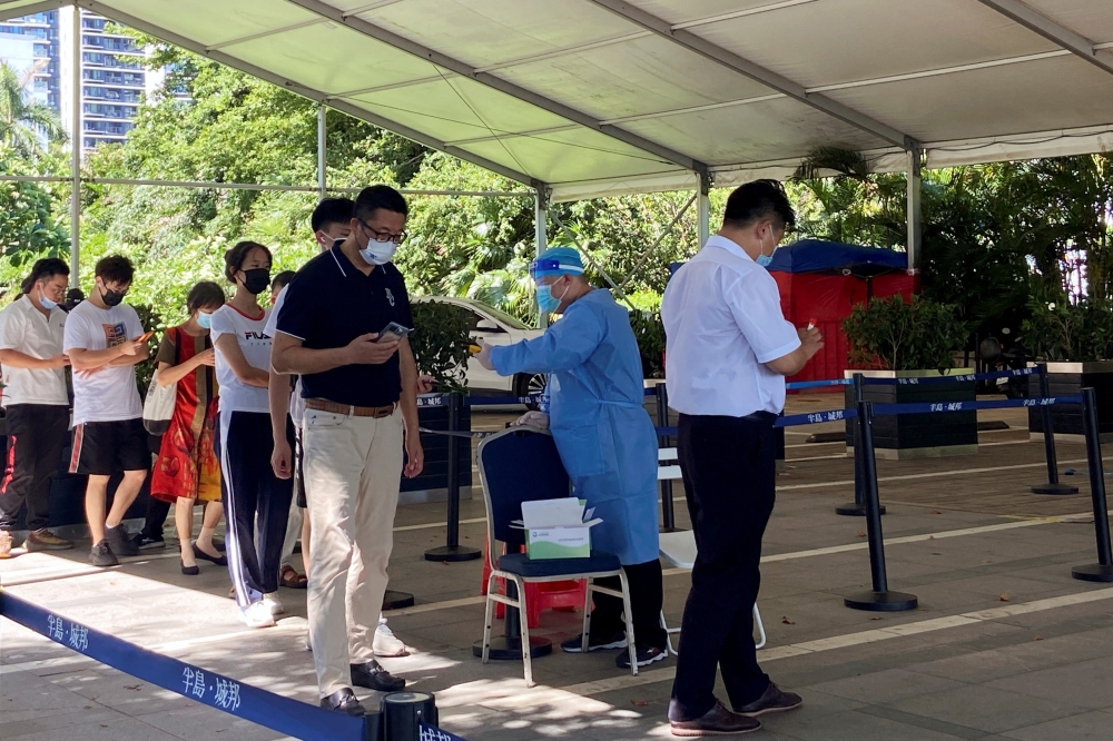 People line up to get tested for Covid-19 at a nucleic acid testing site in Shenzhen, Guangdong province, China on Thursday. — Reuters
