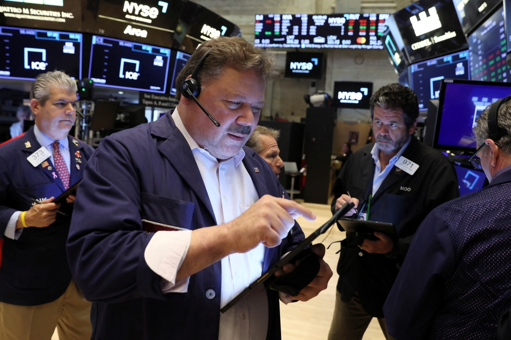 Traders work on the floor of the New York Stock Exchange. - Reuters