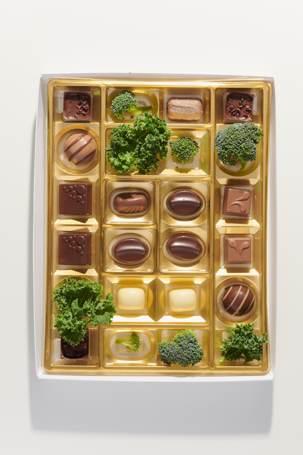 A box of chocolates, with a few pieces of kale and broccoli, in Los Angeles, July 7, 2022. (Aileen Son/The New York Times)