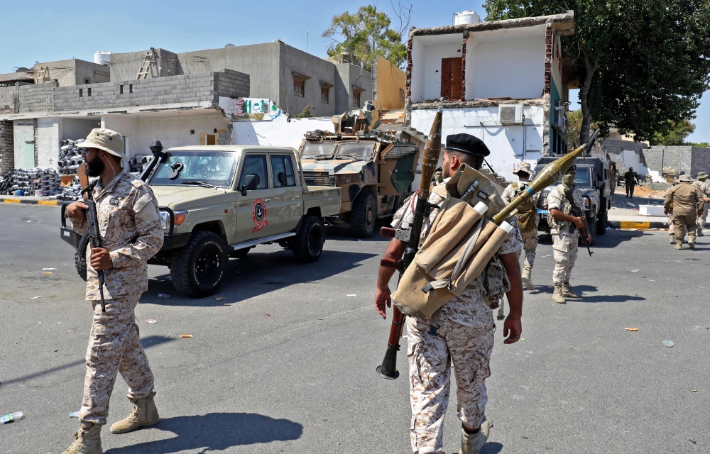 Members of the "444 Brigade" affiliated with Libya's Ministry of Defence man positions in the area of an overnight gunbattle in Tripoli's suburb of Ain Zara, on Friday. - AFP