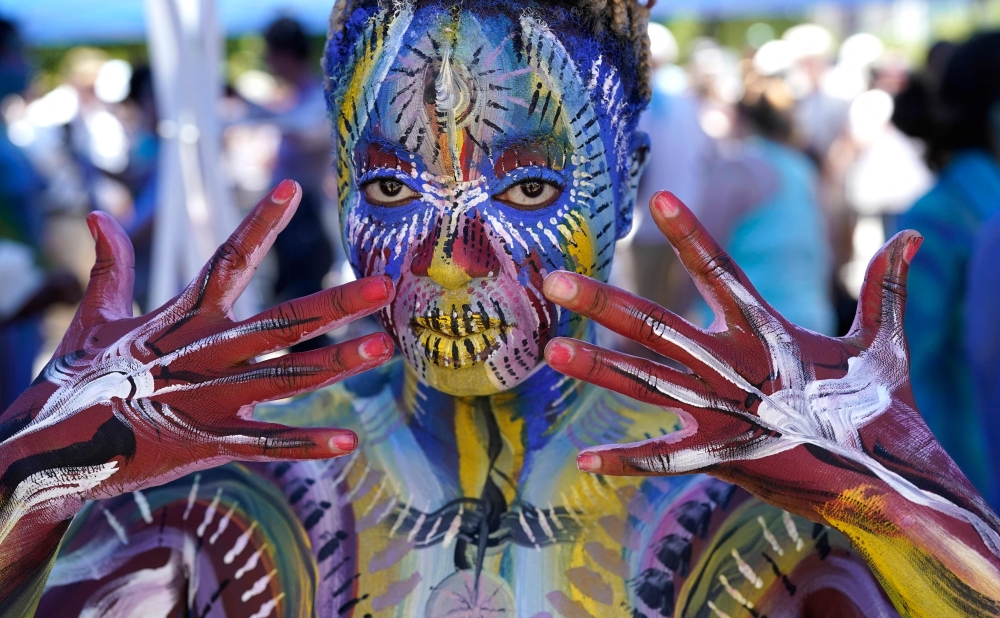 People participate in the the 9th annual NYC Bodypainting Day at Union Square in New York on Monday. The event is organised by Ne York-based artist Andy Golub. -- AFP