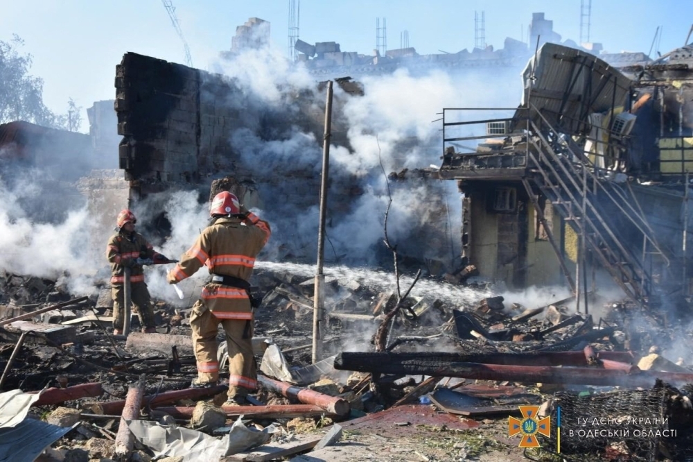 Firefighters work at site of a residential area damaged by a Russia missile strike in the settlement of Zatoka, Odesa region, Ukraine on Tuesday. -- Reuters