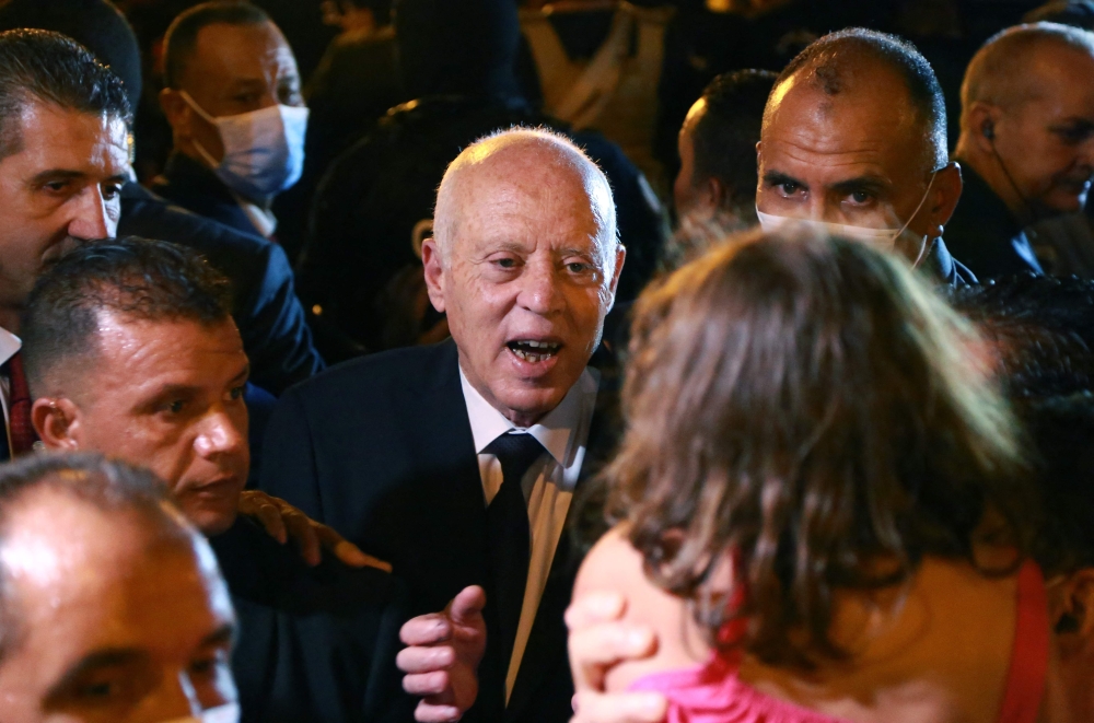President Kais Saied celebrates with his supporters on Habib Bourguiba Avenue in the capital Tunis on Tuesday after the projected outcome was announced. - AFP