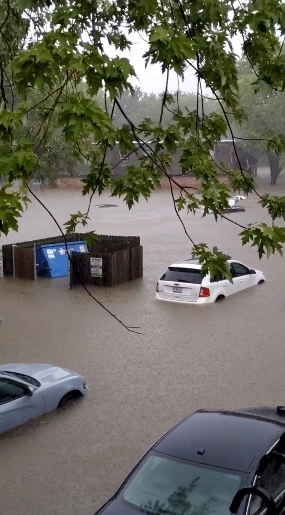 Cars are partially submerged on a flooded street during heavy rainfall in Hazelwood, Missouri, US, in this screen grab obtained from a social media video. - Reuters
