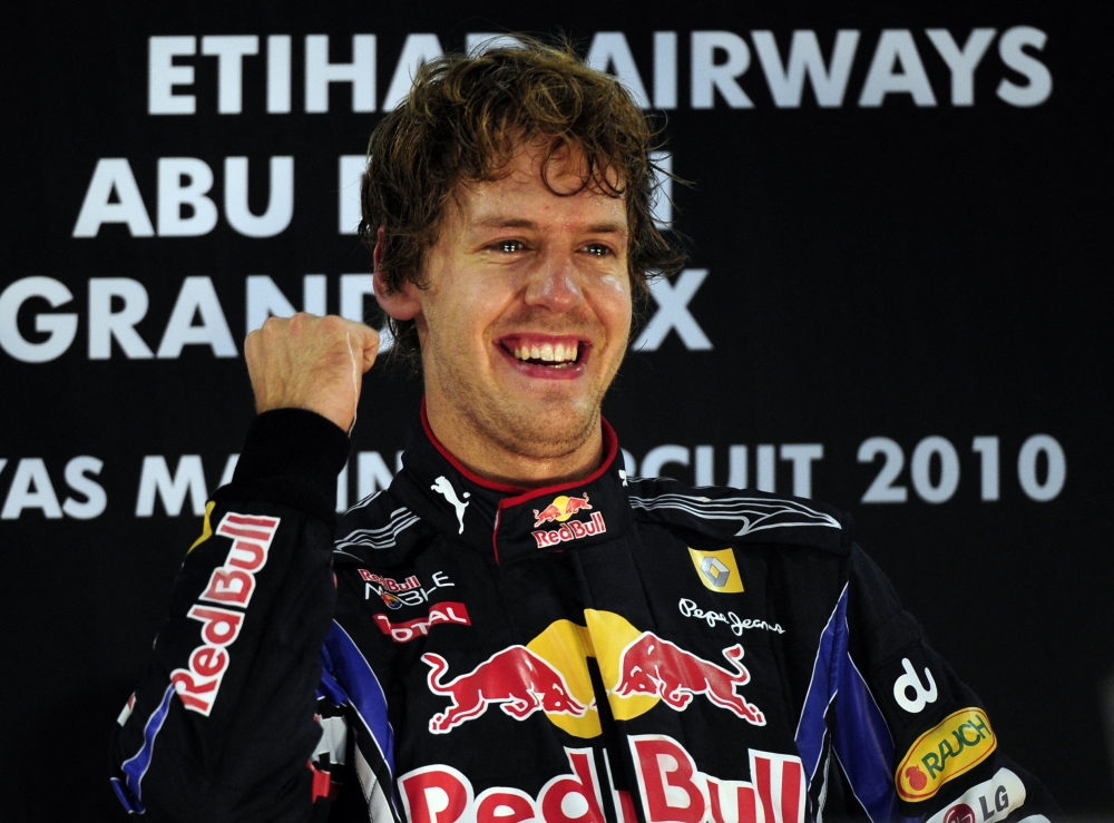 (FILES) In this file photo taken on November 14, 2010 Red Bull's German driver Sebastian Vettel celebrates on the podium of the Yas Marina circuit in Abu Dhabi of the Abu Dhabi Formula One Grand Prix, where he won the race and the 2010 drivers' world championship.   Four-time Formula One world champion Sebastian Vettel will retire at the end of the 2022 season, he announced on July 28, 2022. The 35-year-old German won four successive titles from 2010 to 2013.   (Photo by Fred DUFOUR / AFP)

