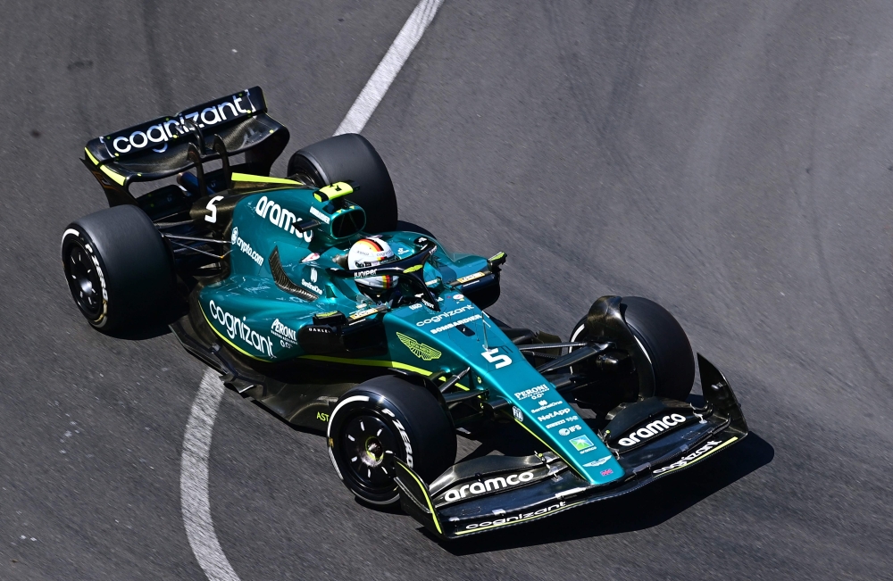 (FILES) In this file photo taken on May 27, 2022 Aston Martin's German driver Sebastian Vettel drives during the first practice session at the Monaco street circuit in Monaco, ahead of the Monaco Formula 1 Grand Prix.
 Four-time Formula One world champion Sebastian Vettel will retire at the end of the 2022 season, he announced on July 28, 2022. The 35-year-old German won four successive titles from 2010 to 2013.   (Photo by ANDREJ ISAKOVIC / AFP)

