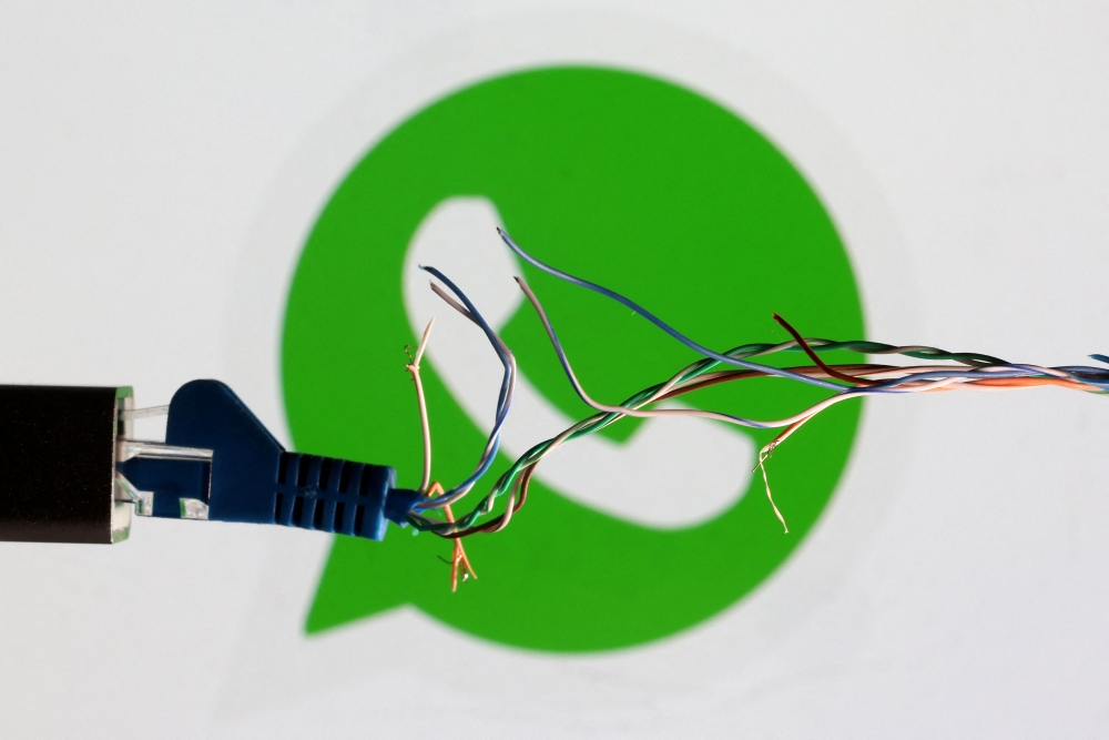 FILE PHOTO: Broken Ethernet cable is seen in front of Whatsapp logo in this illustration taken March 11, 2022. REUTERS/Dado Ruvic/Illustration/File Photo