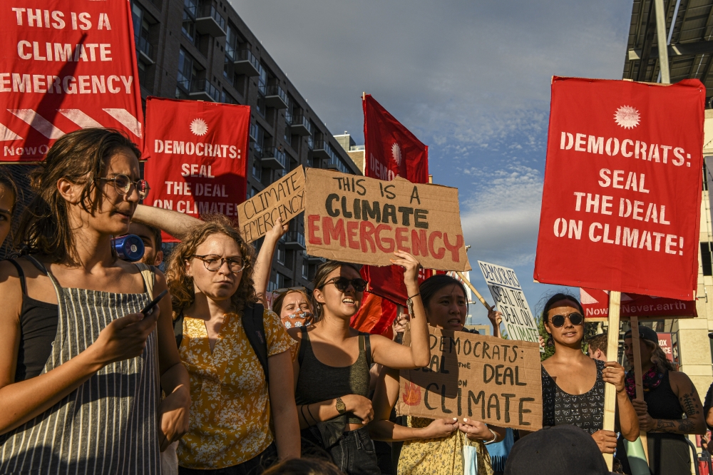 Climate activists block gates to the Congressional Baseball Game at Nationals Park during a demonstration in Washington, July 28, 2022. (Kenny Holston/The New York Times)