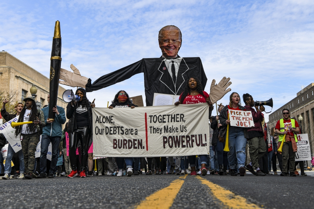 A rally by activist groups urging the cancellation of student debt outside the Department of Education in Washington, April 4, 2022. (Kenny Holston/The New York Times)