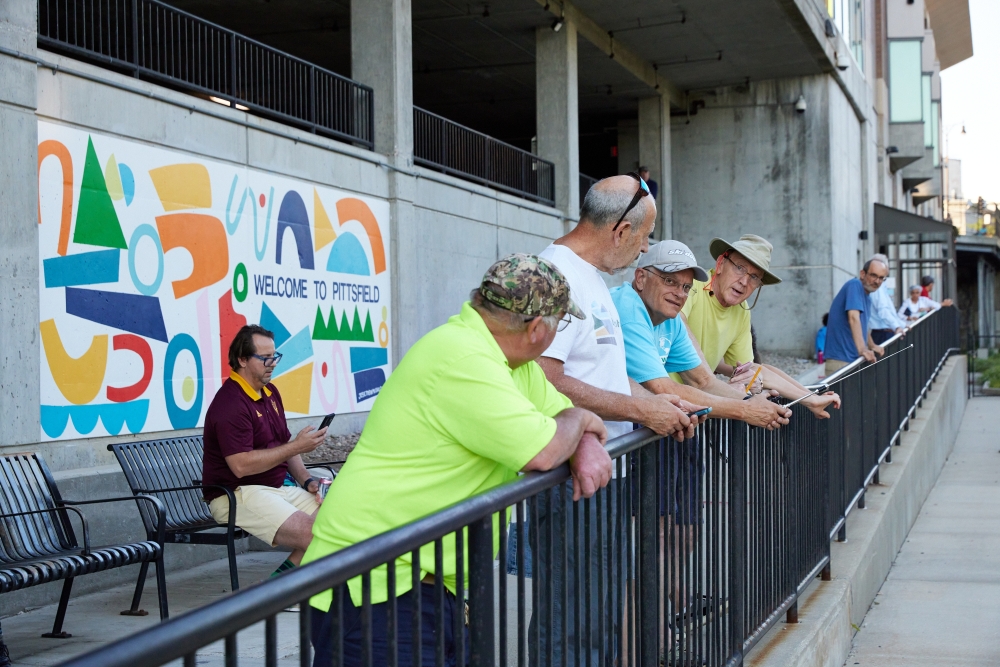Men speak while waiting at the Joseph Scelsi Intermodal Transportation Center in Pittsfield, Mass., July 28, 2022. (Tara Donne/The New York Times)