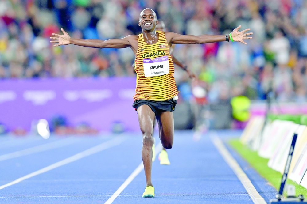 Gold medallist Uganda's Jacob Kiplimo celebrates after winning the men's 10,000m final athletics event at the Alexander Stadium, in Birmingham on day five of the Commonwealth Games in Birmingham, central England, on August 2, 2022. (Photo by Glyn KIRK / AFP)

