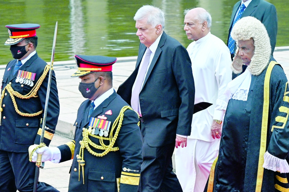Sri Lanka's President Ranil Wickremesinghe (C), Prime Minister Dinesh Gunawardena and Speaker Mahinda Yapa Abeywardena leave Parliament after opening a new session in Colombo on Wednesday. -- AFP