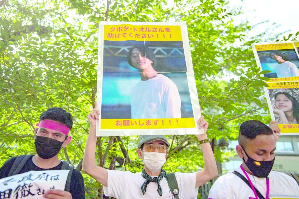In this file photo taken on July 31, a group of activists hold placards of Japanese citizen Toru Kubota, who is detained in Myanmar, during a rally in front of the Ministry of Foreign Affairs in Tokyo. - AFP 