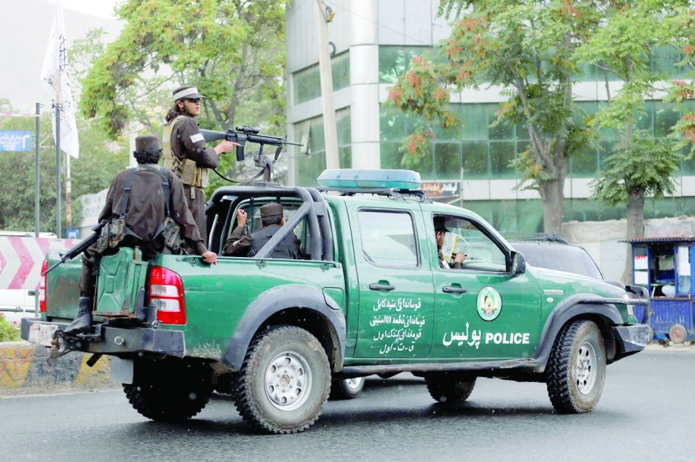 Taliban fighters drive a car on a street following the killing of Al Qaeda leader Ayman al Zawahiri in a US strike over the weekend, in Kabul. - Reuters