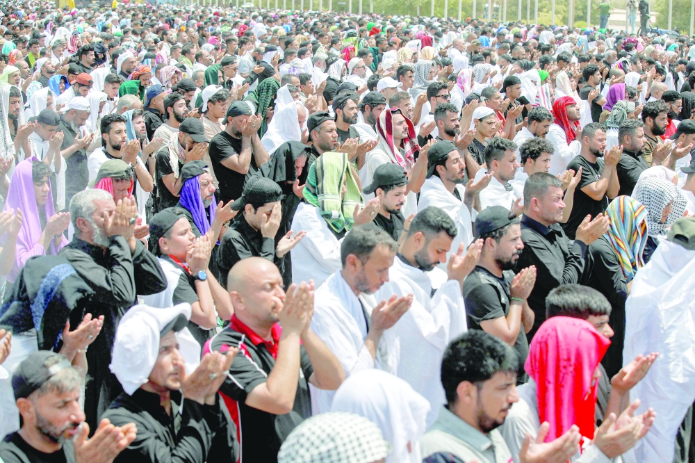 Supporters of Moqtada Sadr perform the Friday prayers at Baghdad's high-security Green Zone as they continue their protest against a nomination for prime minister by a rival faction. - AFP