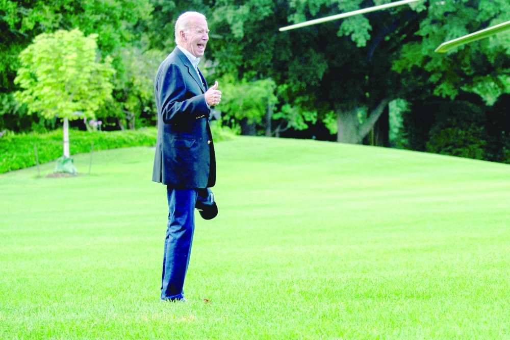 US President Joe Biden gives a thumbs up while walking to Marine One on the South Lawn of the White House on Sunday. -- AFP