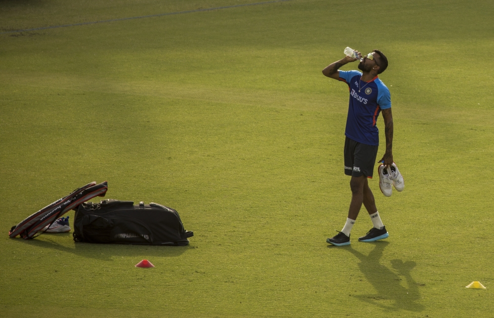 Indian cricket player Hardik Pandya pauses for a drink during practice before a match between India and South Africa, at Arun Jaitley Stadium in New Delhi, on June 8, 2022. (Anindito Mukherjee/The New York Times)