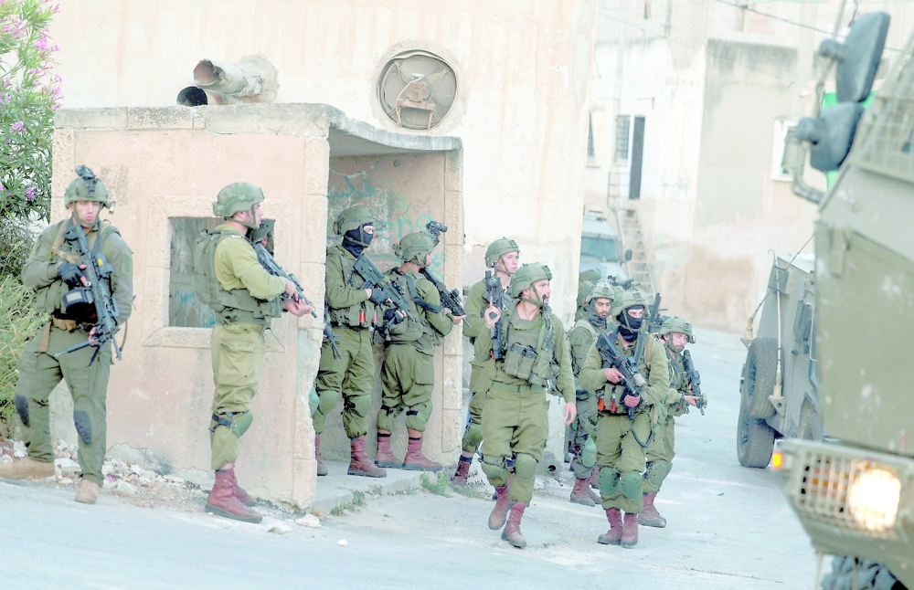Israeli soldiers deploy to demolish houses in Rummanah town in the occupied West Bank. -- AFP