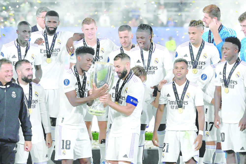 Real Madrid players celebrate with the trophy after the UEFA Super Cup football match between Real Madrid vs Eintracht Frankfurt in Helsinki on Wednesday. — AFP
