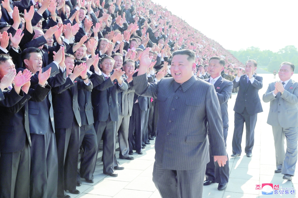 North Korea's leader Kim Jong Un greets health workers and scientists struggling with the Covid-19 pandemic during a photo session in Pyongyang, in this undated photo released on Thursday by North Korea's Korean Central News Agency. - Reuters 
