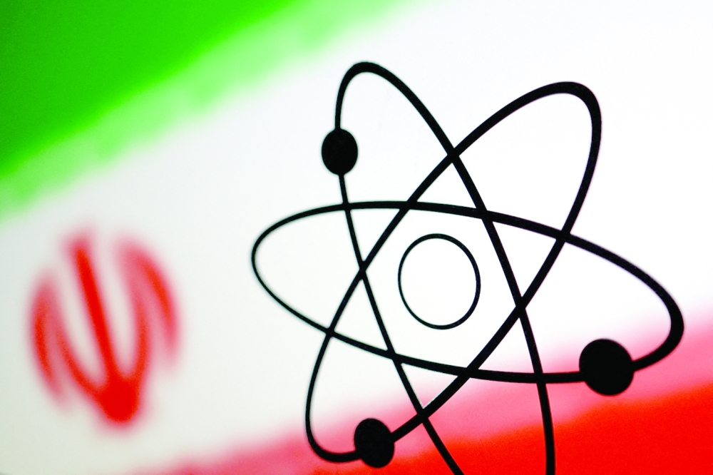 The atomic symbol and the Iranian flag are seen in this illustration. - Reuters