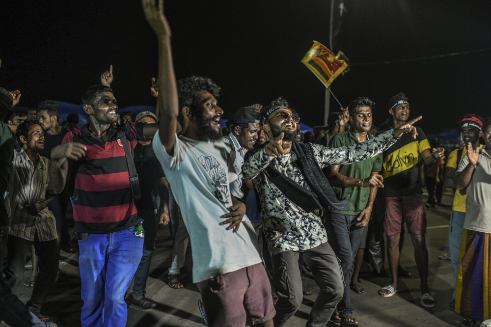 Protesters celebrate after the resignation of President Gotabaya Rajapaksa in Colombo, Sri Lanka, on July 14, 2022. (Atul Loke/The New York Times)