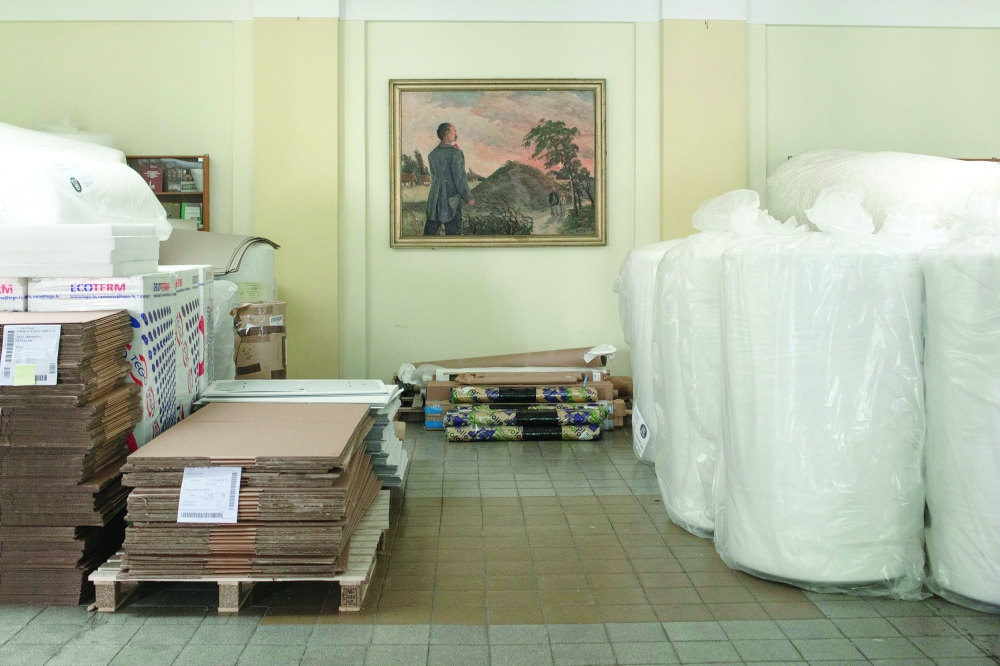 Piles of cardboard and reams of plastic film fill the lobby of a university library in Lviv, Ukraine, July 1, 2022. (Emile Ducke/The New York Times)
