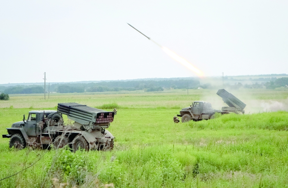 Ukrainian servicemen fire with a BM21 Grad multiple launch rocket system in a frontline in Kharkiv region, as Russia's attack on Ukraine continues. -- Reuters