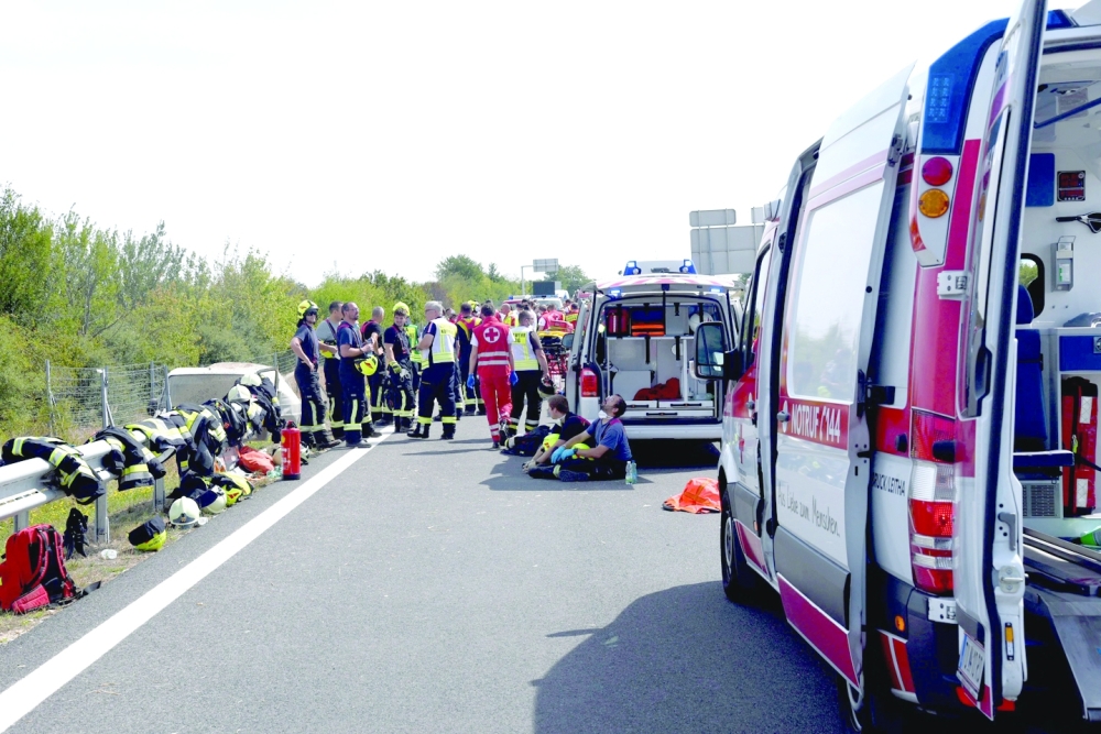 Emergency personnel are seen at an accident site on the A6 freeway at the Kittsee border crossing, northeastern Austria. A people smuggler rolled over with his overcrowded van while trying to escape a police check on the freeway. -- AFP

A van rolled over while trying to escape a police check on the northeastern freeway (A6) at the Kittsee border crossing. Three people were killed in the accident. -- AFP