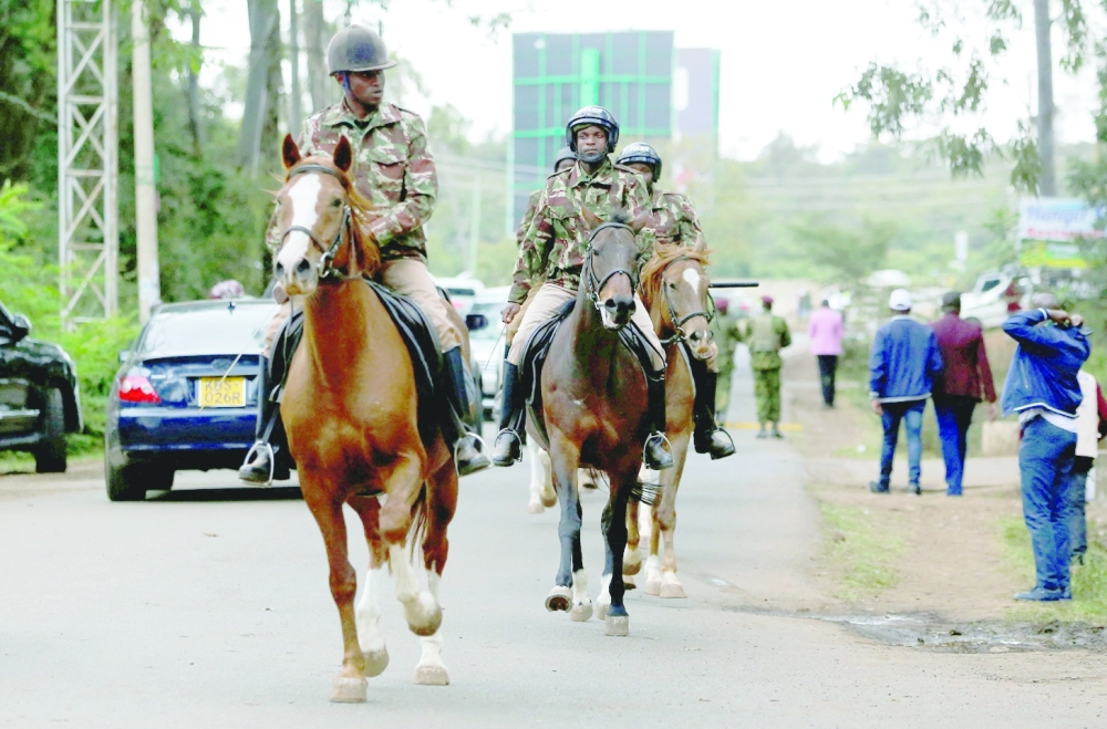 Riot police officers on horses patrol as they secure the Independent Electoral and Boundaries Commission (IEBC) National tallying centre at the Bomas of Kenya in Nairobi. -- Reuters