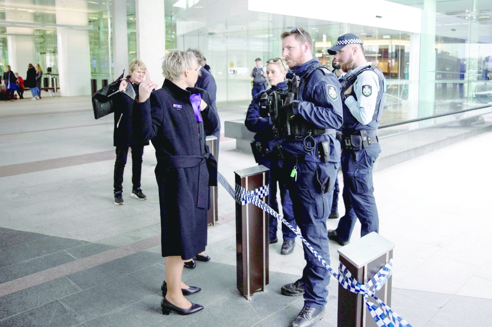 Police speak with witnesses after a gunman opened fire at the airport in Canberra. - AFP
