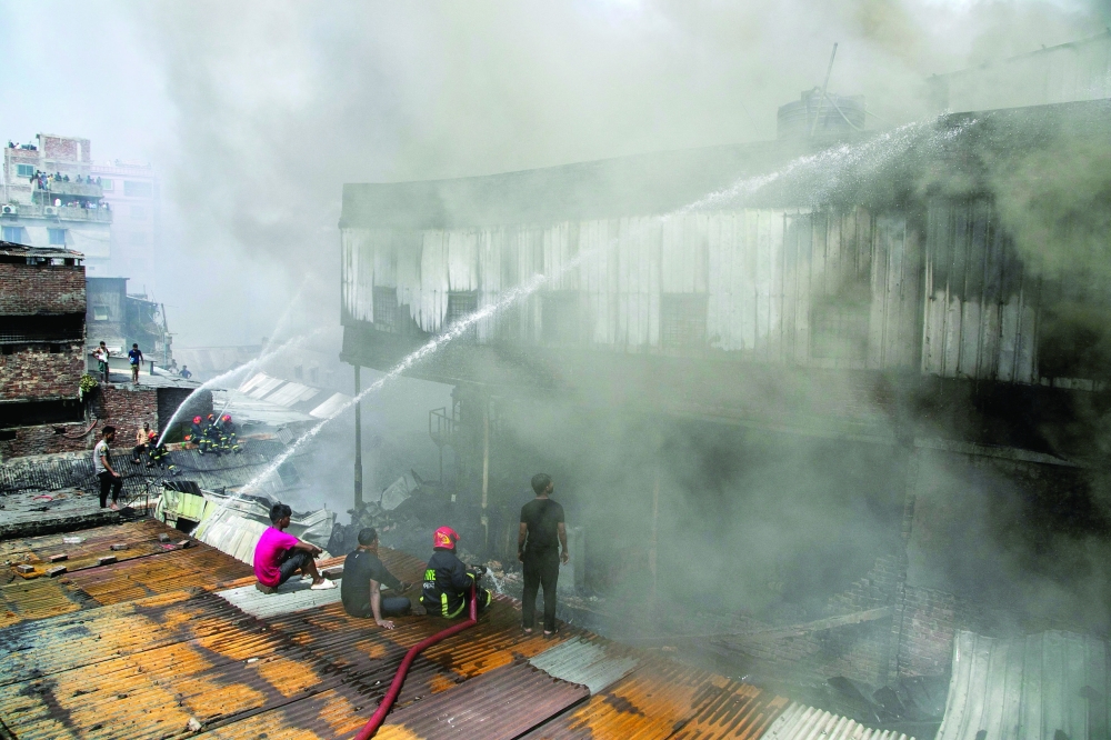 Firefighters try to douse a fire that broke out in a plastic factory at Chawkbazar area in Dhaka, Bangladesh, August 15, 2022. REUTERS/Stringer       NO RESALES. NO ARCHIVES.

