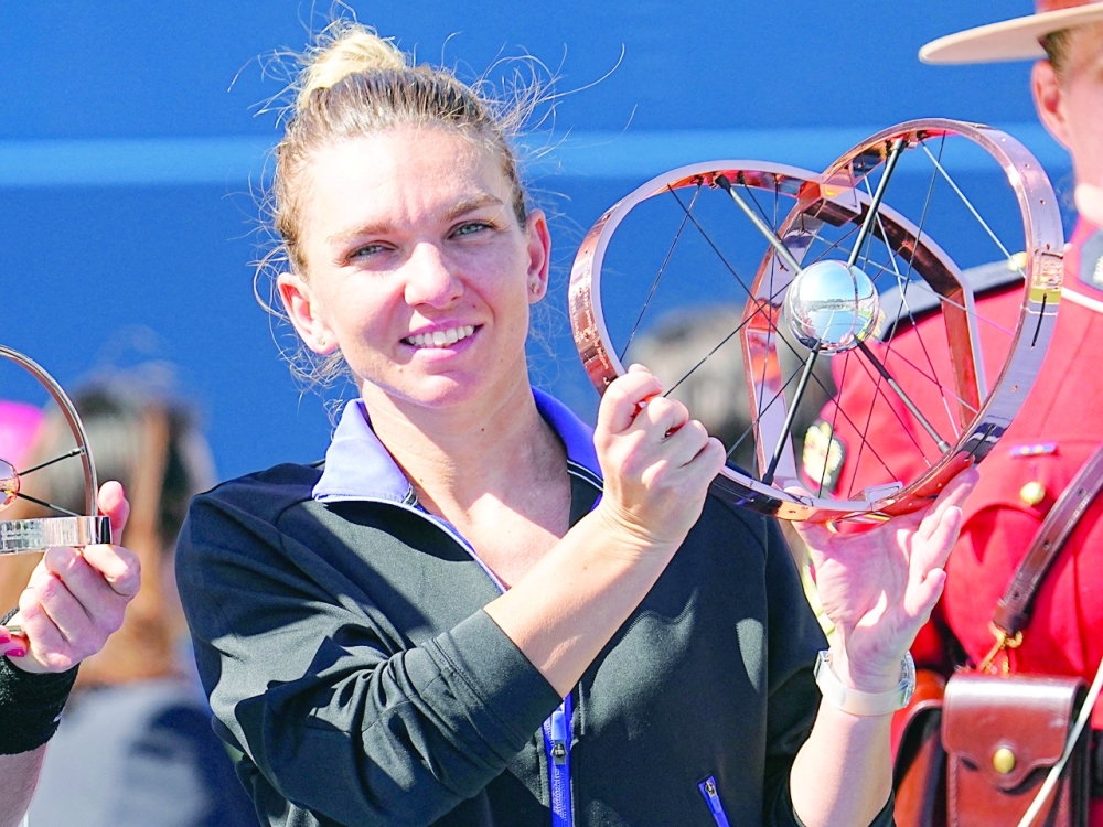 Simona Halep (ROU) poses with the National Bank Open trophy after defeating Beatriz Haddad Maia (not pictured)  in the women's final of the National Bank Open at Sobeys Stadium. - USA TODAY Sports
