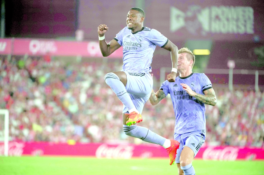 TOPSHOT - Real Madrid's Austrian defender David Alaba (L) celebrates scoring this team's second goal during the Spanish league football match between UD Almeria and Real Madrid CF at the Municipal Stadium of the Mediterranean Games in Almeria on August 14, 2022. (Photo by JORGE GUERRERO / AFP)

