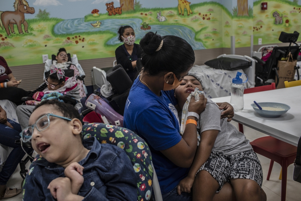 Children with microcephaly and other debilitations due to Zika infections at birth with their mothers at clinic in Recife, Brazil, June 2, 2022. (Dado Galdieri/The New York Times)