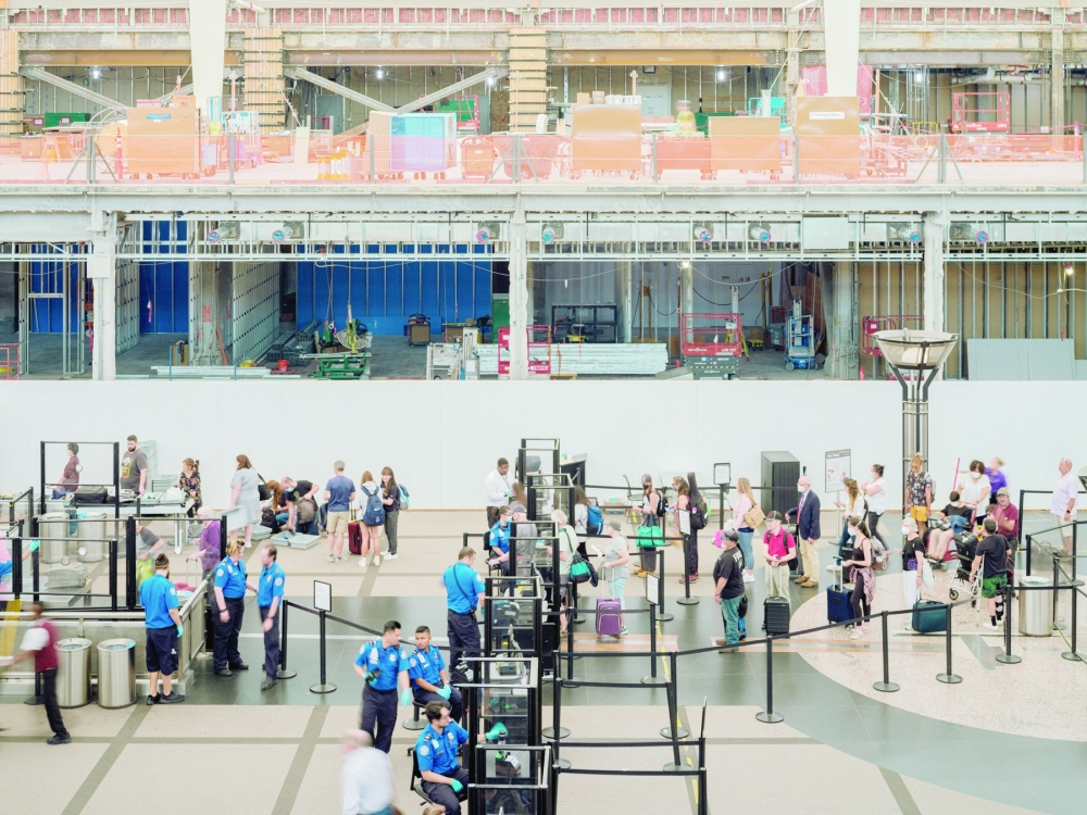 Construction goes on above and around a security line at Denver International Airport, July 22, 2022. (Benjamin Rasmussen/The New York Times)