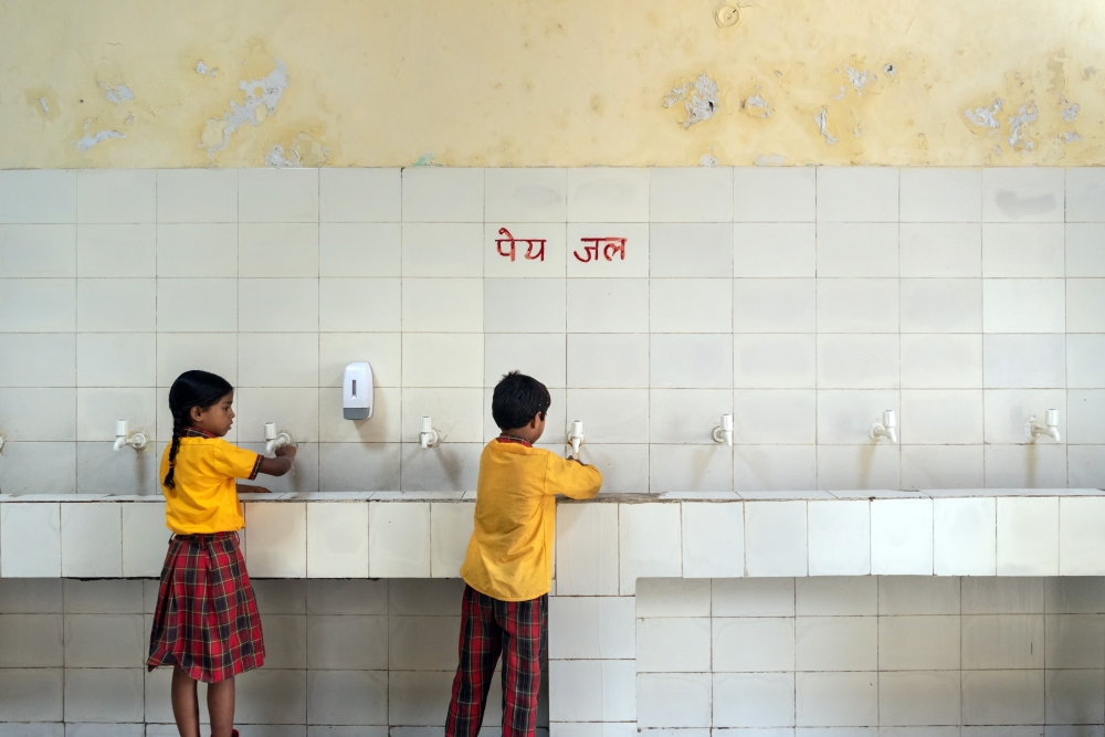 Students get clean drinking water at Sarvodaya Vidyalaya, a public school in New Delhi, on July 5, 2022. Until recently, some schools had no drinking water and no clean toilets.  (Saumya Khandelwal/The New York Times)