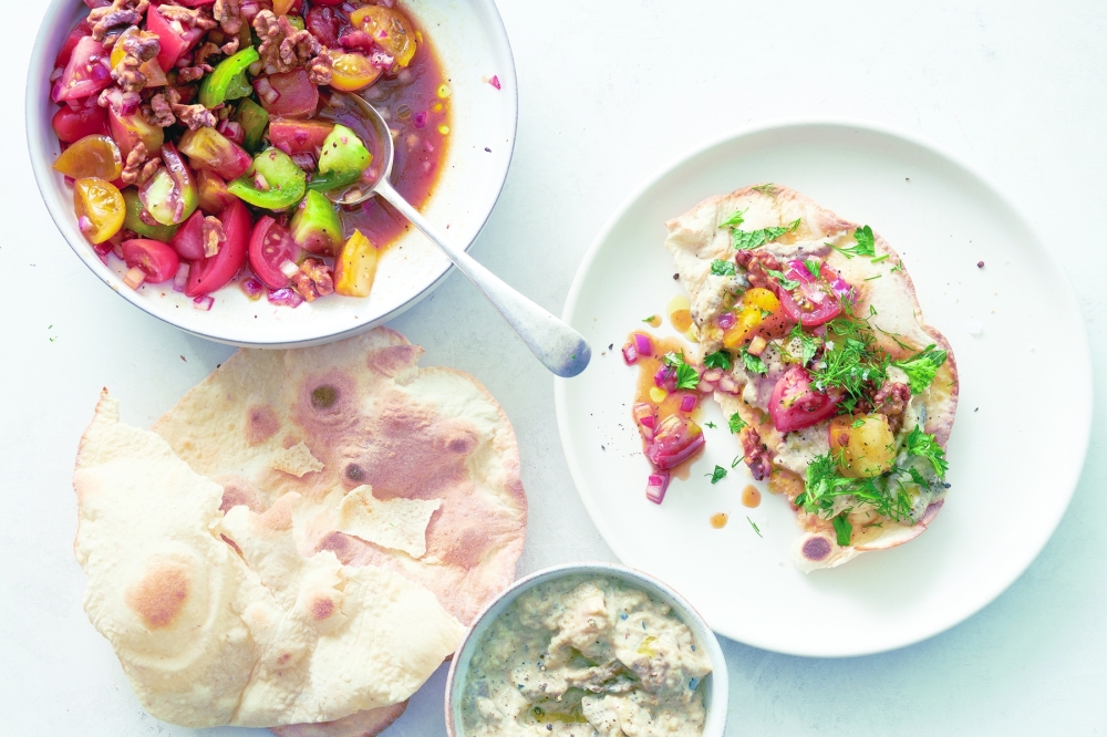 Tomato salad with smoky eggplant flatbread in New York, Aug. 4, 2022. Food styled by Simon Andrews. (David Malosh/The New York Times)
