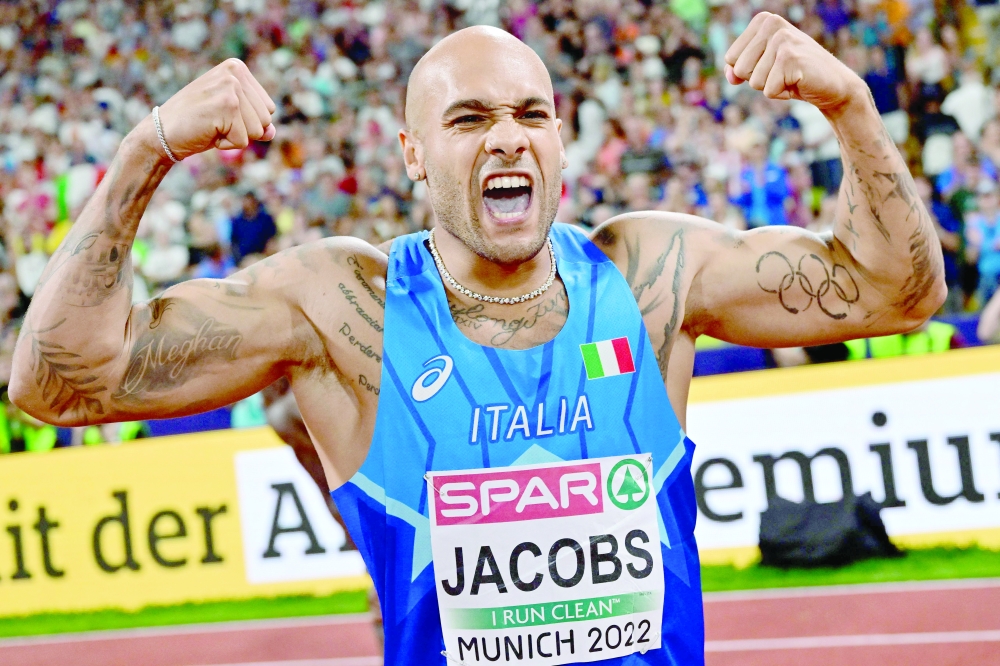TOPSHOT - Italy's Lamont Marcell Jacobs celebrates winning a gold in the men's 100m final during the European Athletics Championships at the Olympic Stadium in Munich, southern Germany on August 16, 2022. (Photo by ANDREJ ISAKOVIC / AFP)

