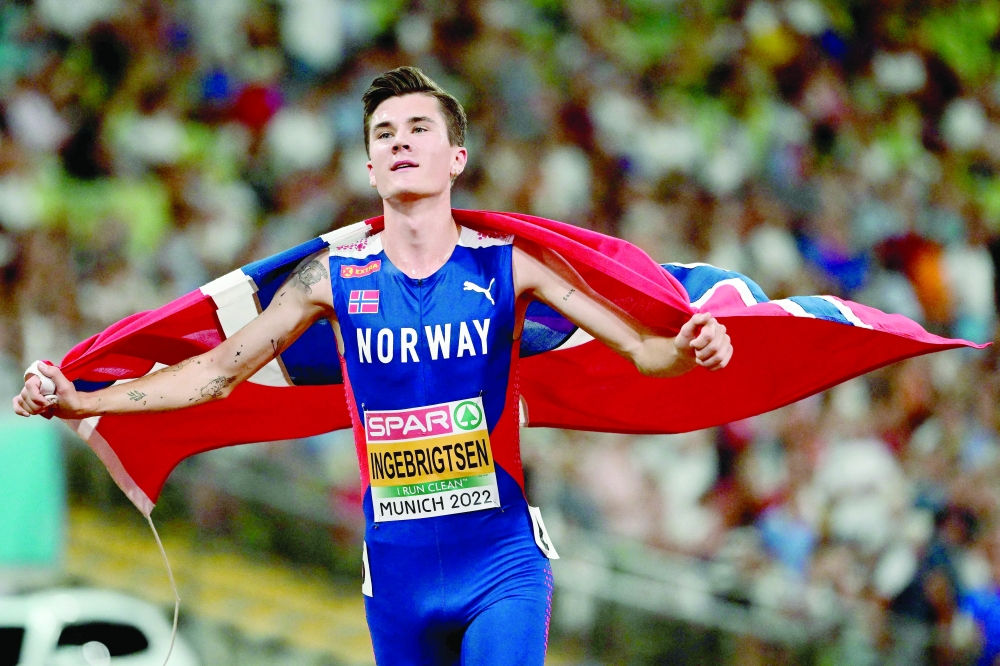 TOPSHOT - Norway's Jakob Ingebrigtsen celebrates winning the men's 5000m final during the European Athletics Championships at the Olympic Stadium in Munich, southern Germany on August 16, 2022. Norway's Jakob Ingebrigtsen won gold ahead of Spain's Mohamed Katir and Italy's Yemaneberhan Crippa. (Photo by INA FASSBENDER / AFP)

